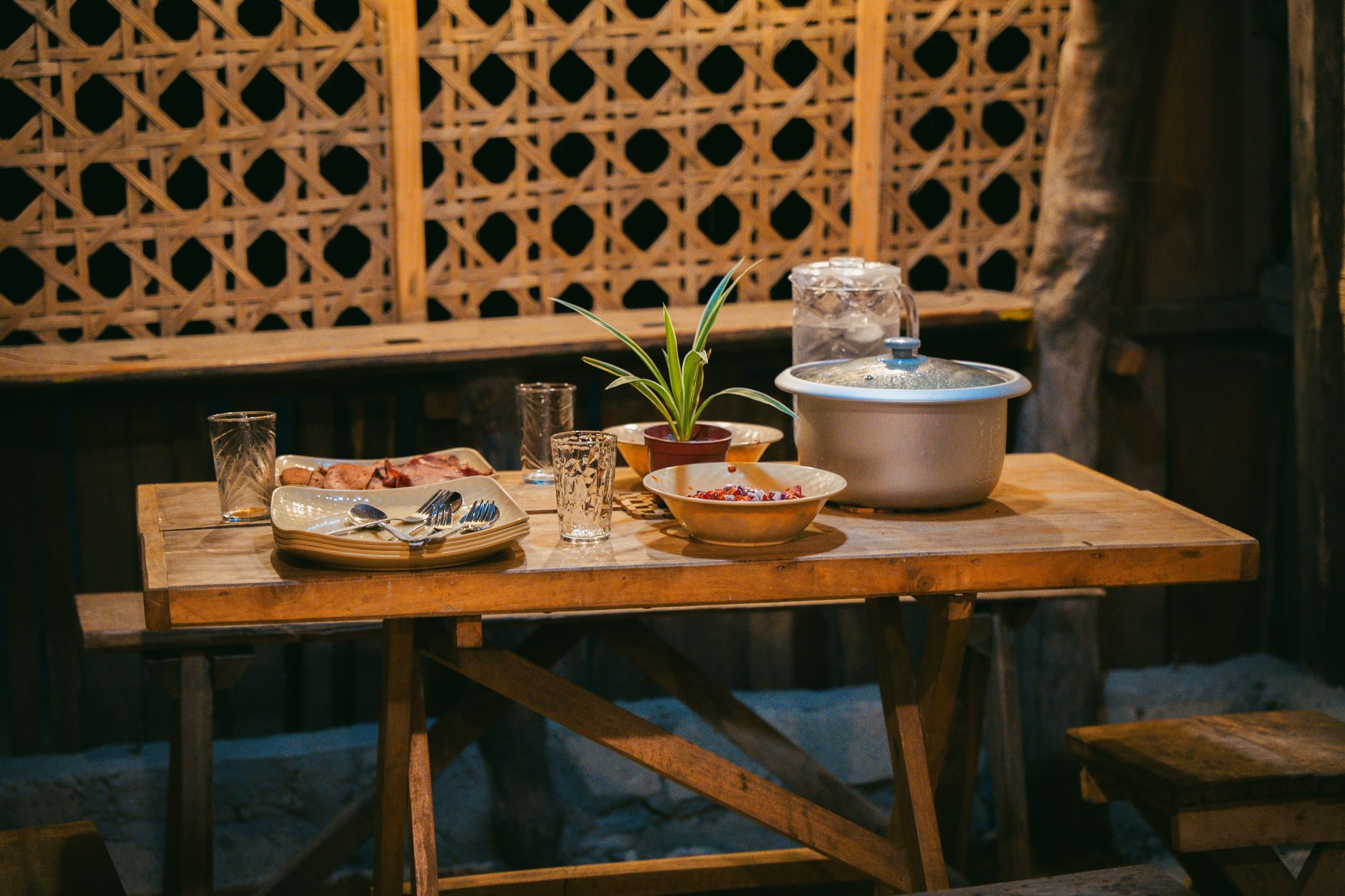 A wooden dining table set for a meal