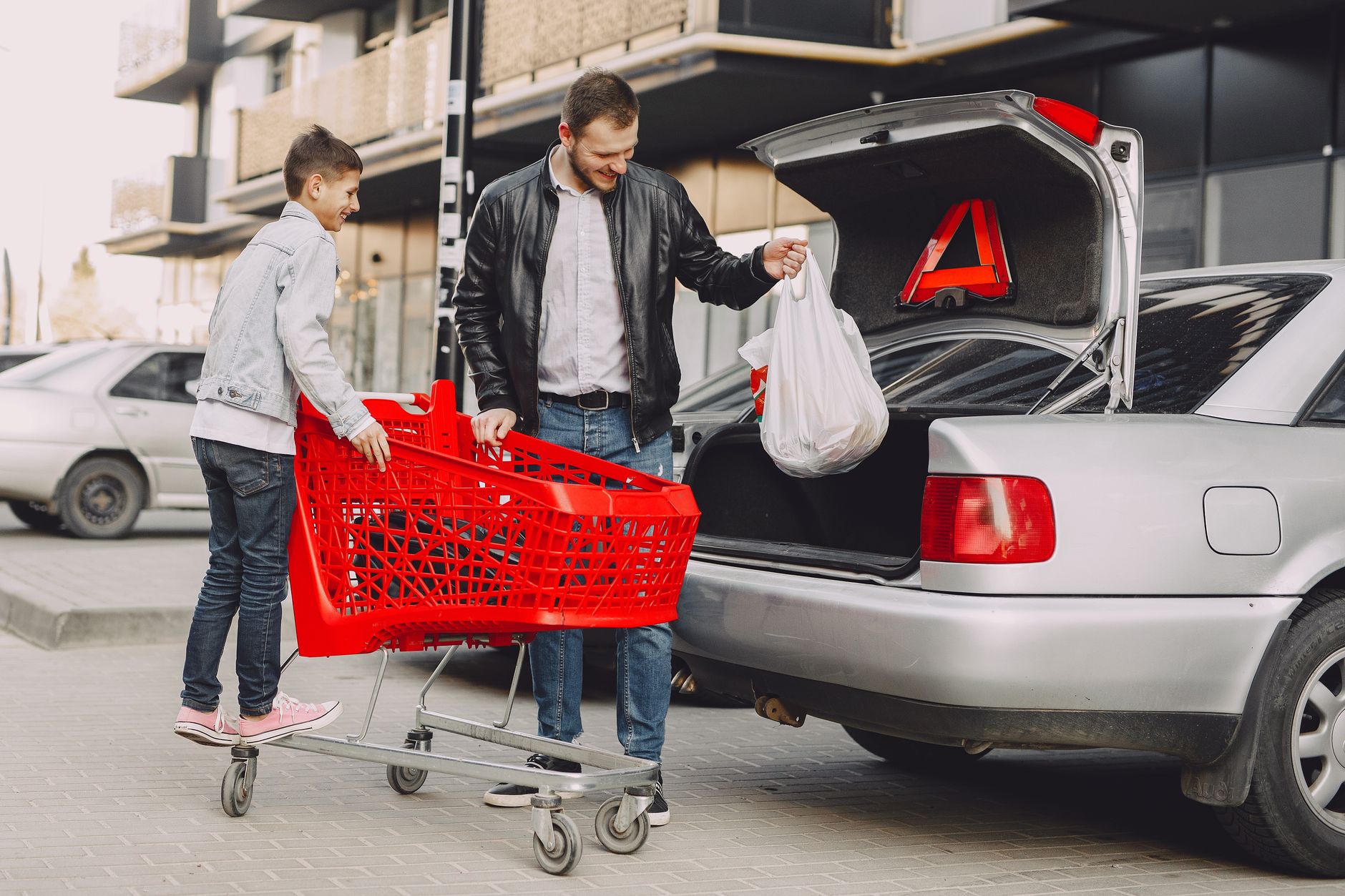 Loading grocery bags from a cart into a trunk