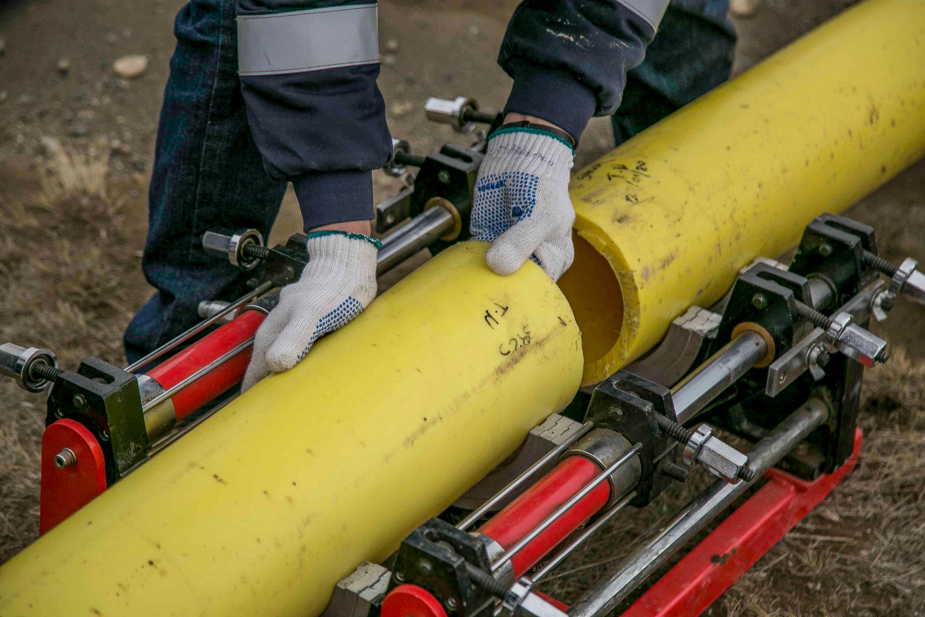 Workers fusing a plastic pipe