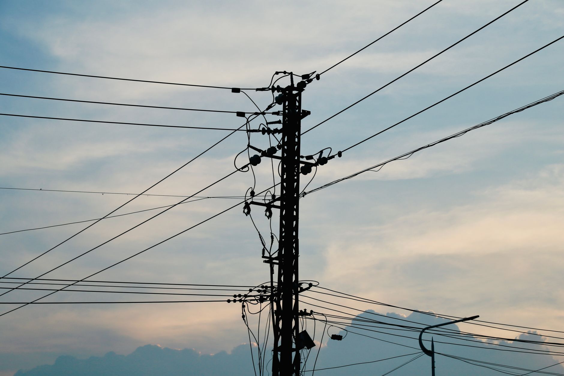 Overhead power lines against the sky