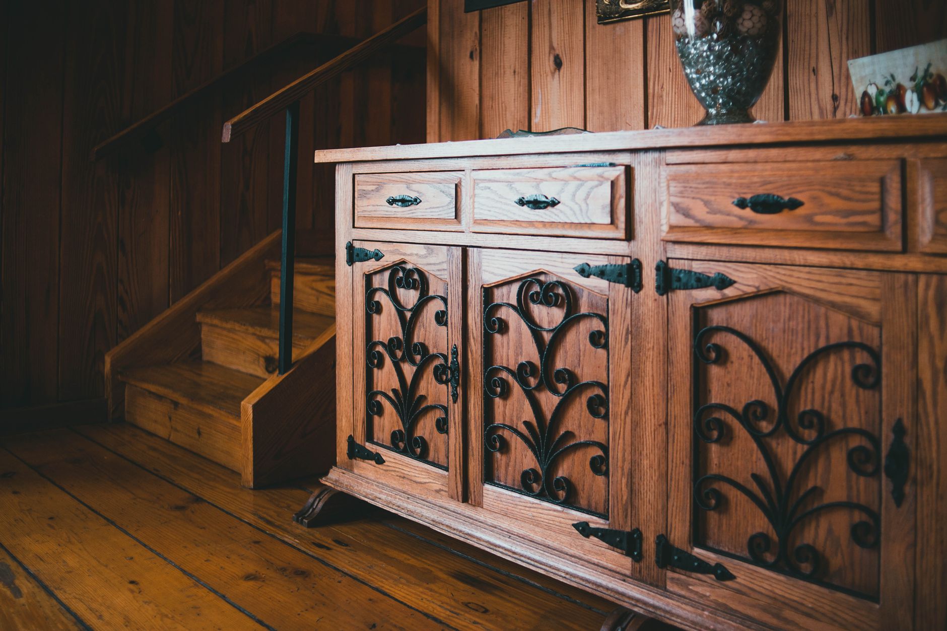 A wooden sideboard with decor on top