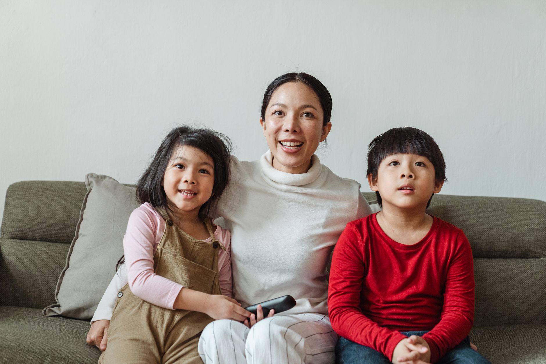 A family watching a movie from the sofa