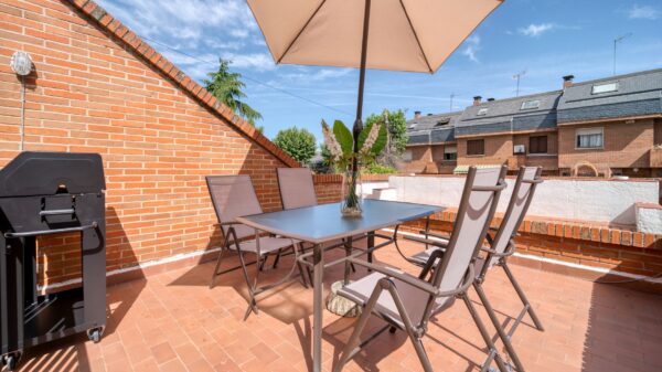 Best umbrella base: a patio table with an open umbrella