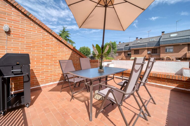 Best umbrella base: a patio table with an open umbrella
