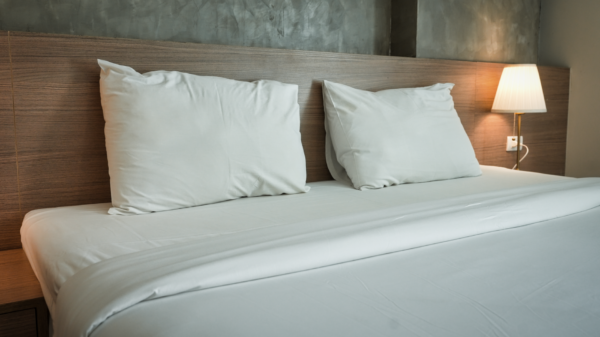 Best under bed storage: a made bed with a lamp