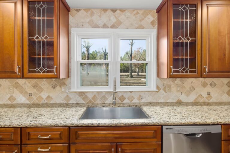 Best under sink organizer: a kitchen sink above wood cabinets