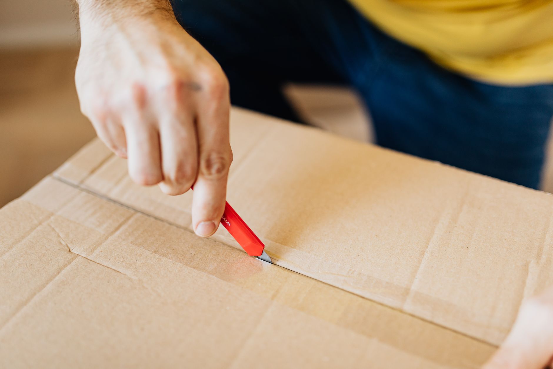 Best utility knife: cutting a cardboard box with a box cutter