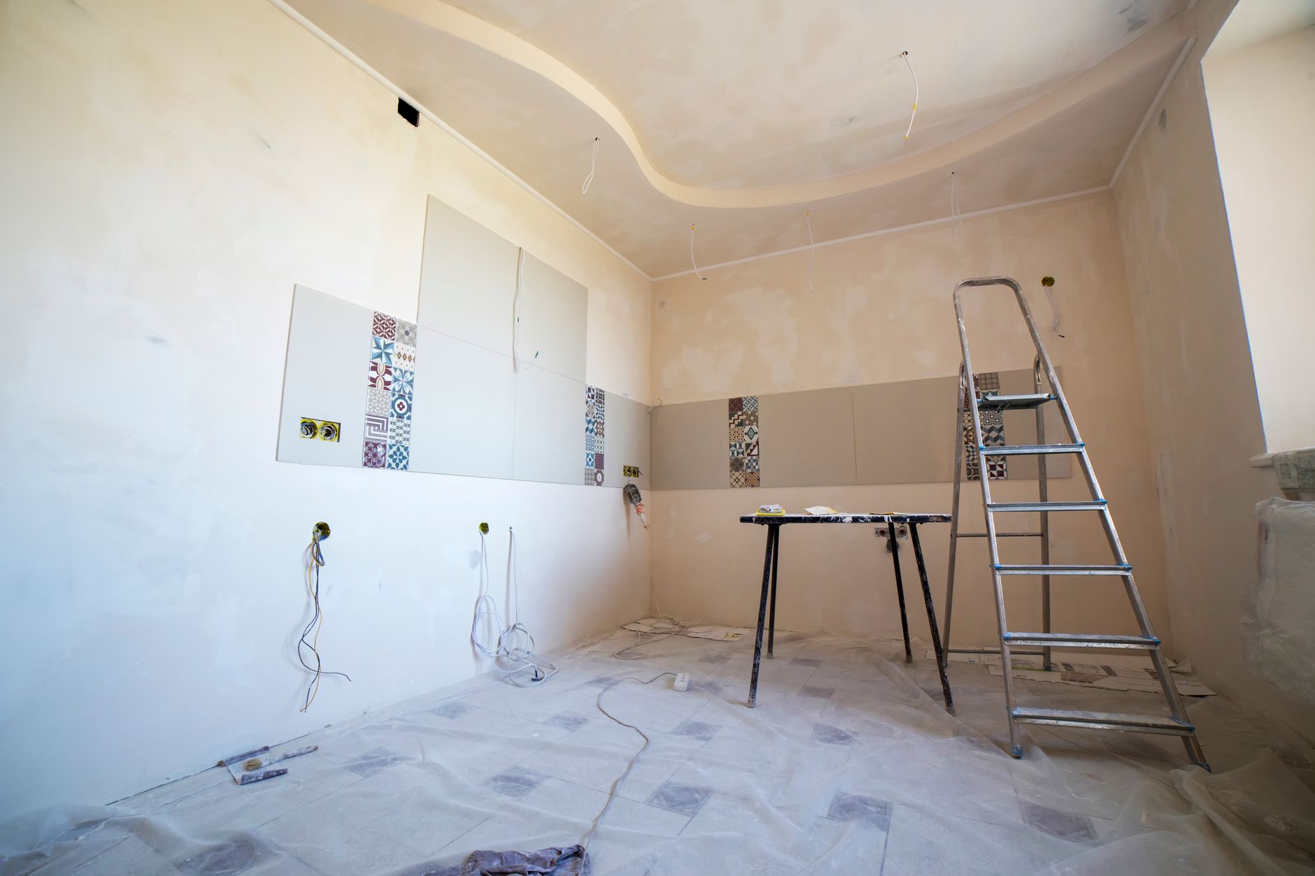 A room under renovation with a ladder