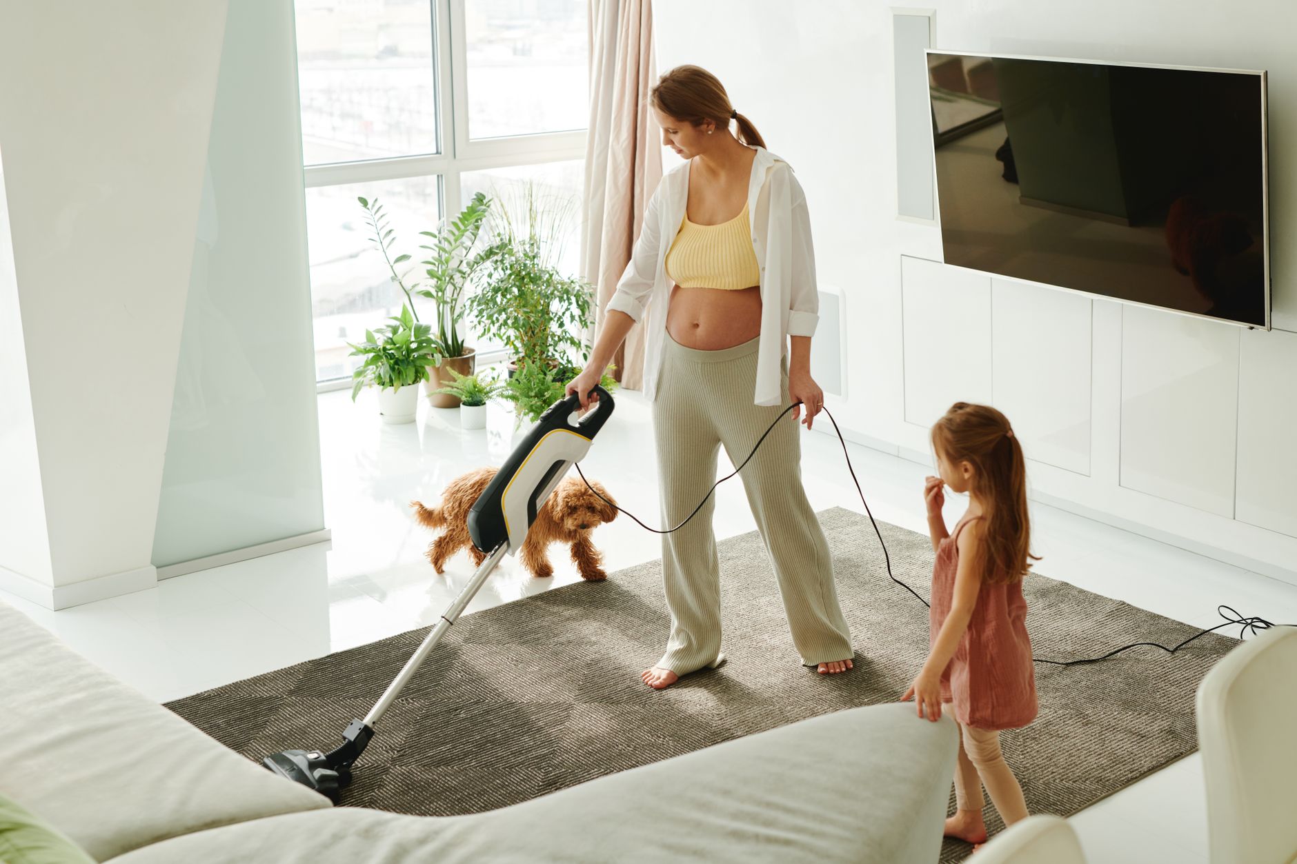 Vacuuming a carpeted floor at home