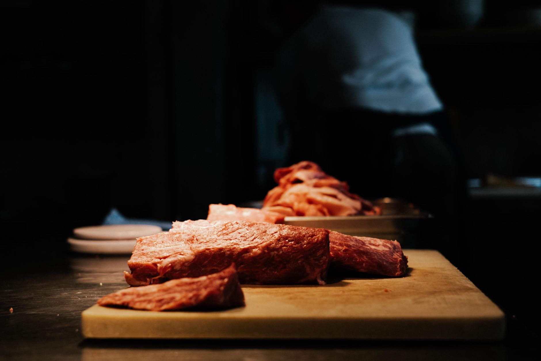 Raw meat on a cutting board in a kitchen
