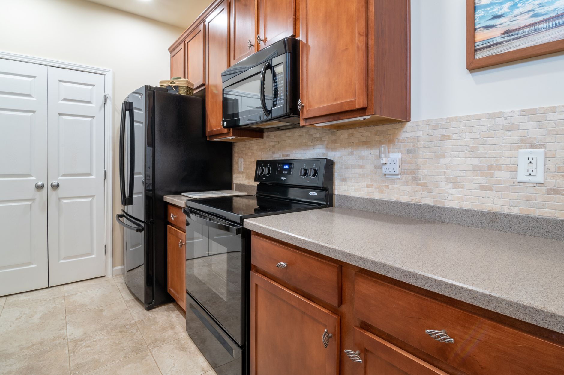Kitchen with a stove, microwave and fridge