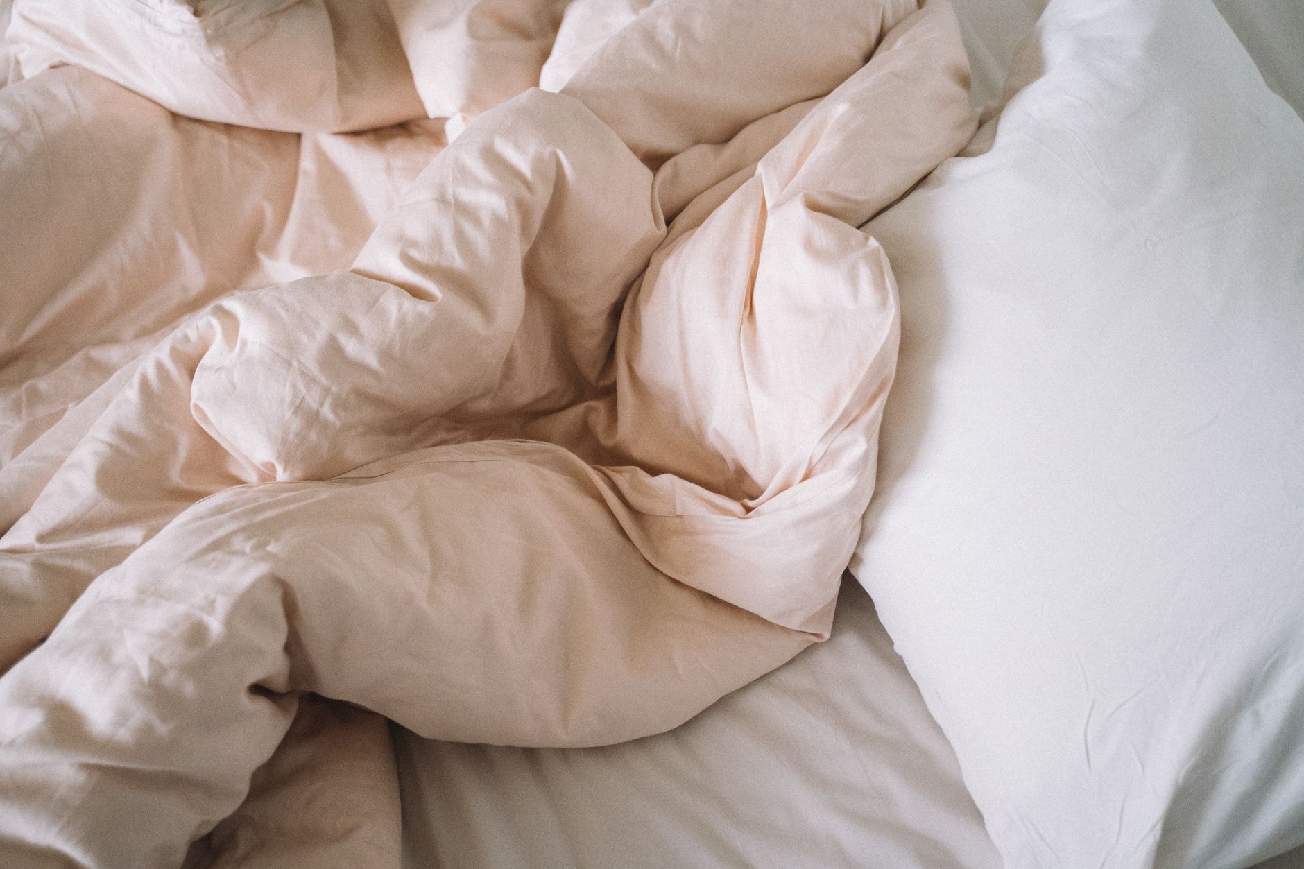 A rumpled duvet on a bed