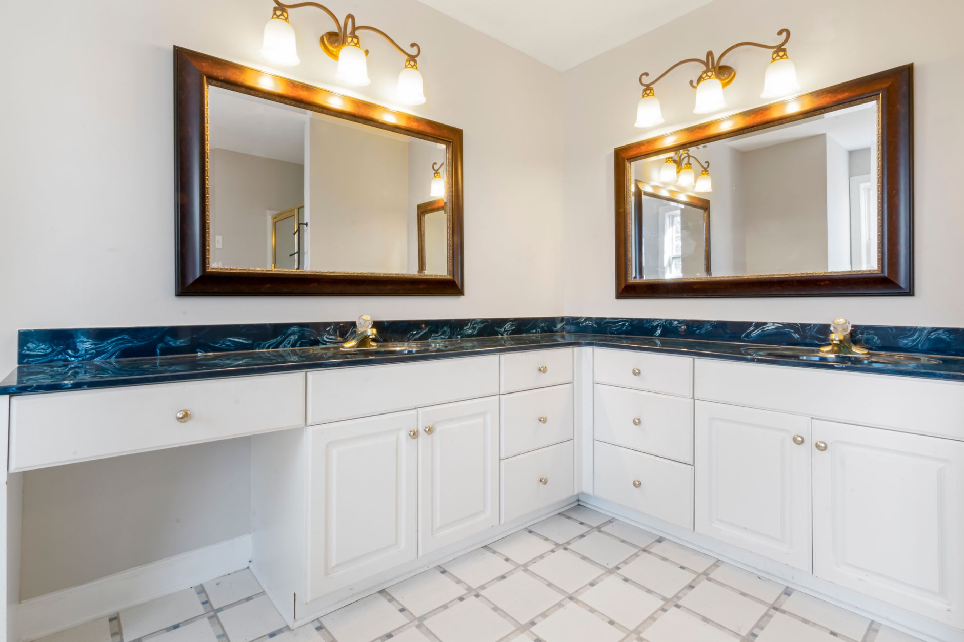 A bathroom counter with a mirror above it