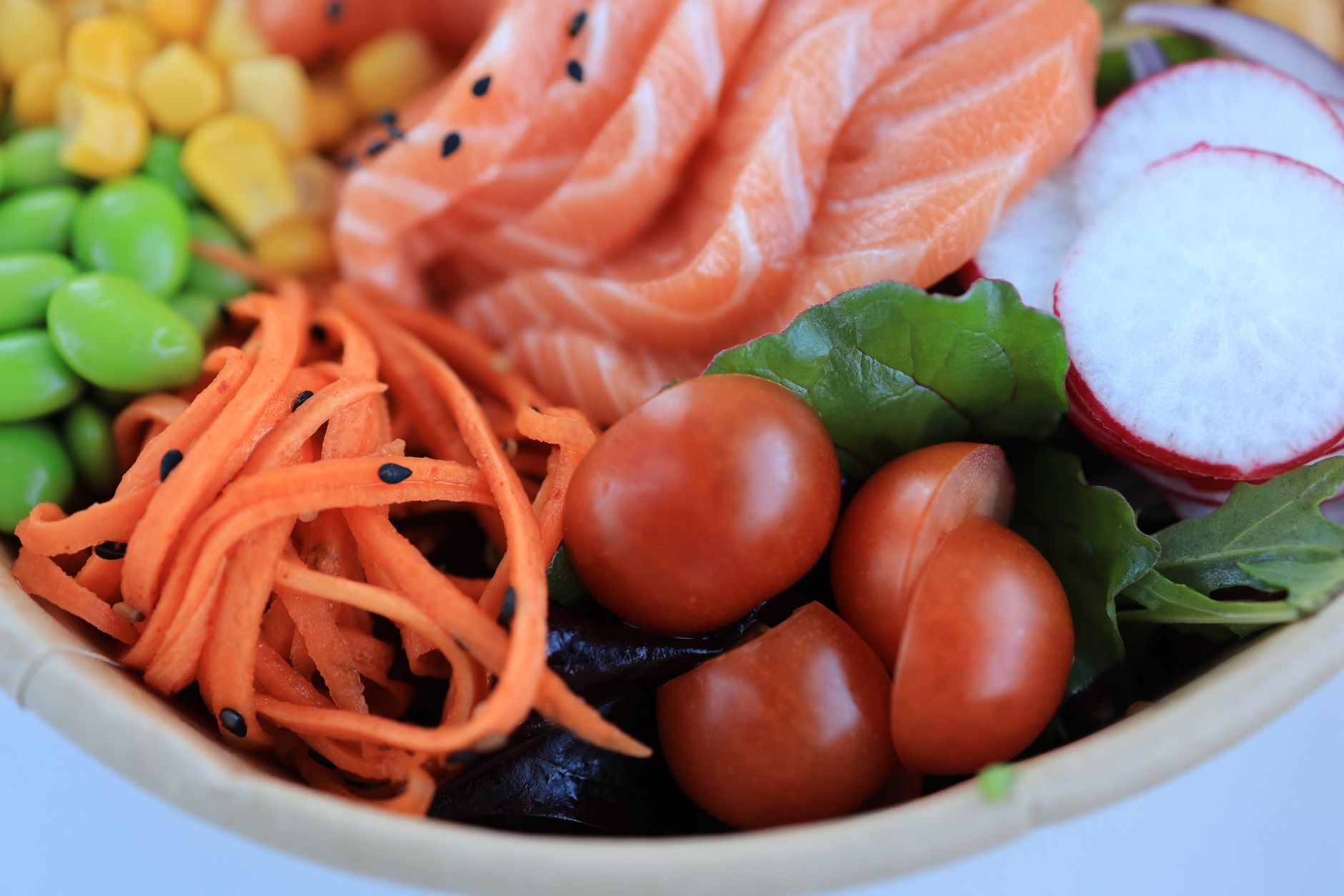 A bowl of salmon, carrots and tomatoes
