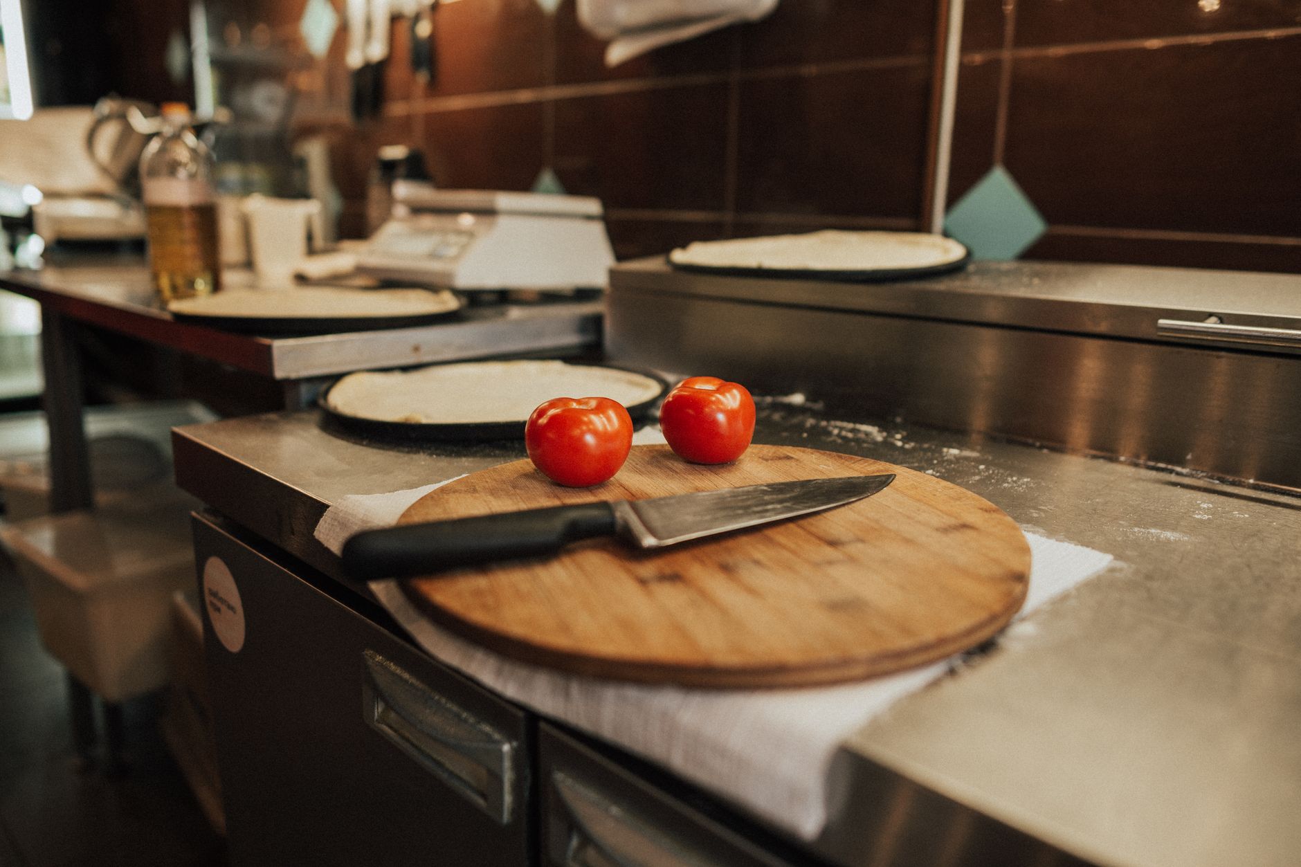 Tomatoes on a wooden board in a commercial kitchen