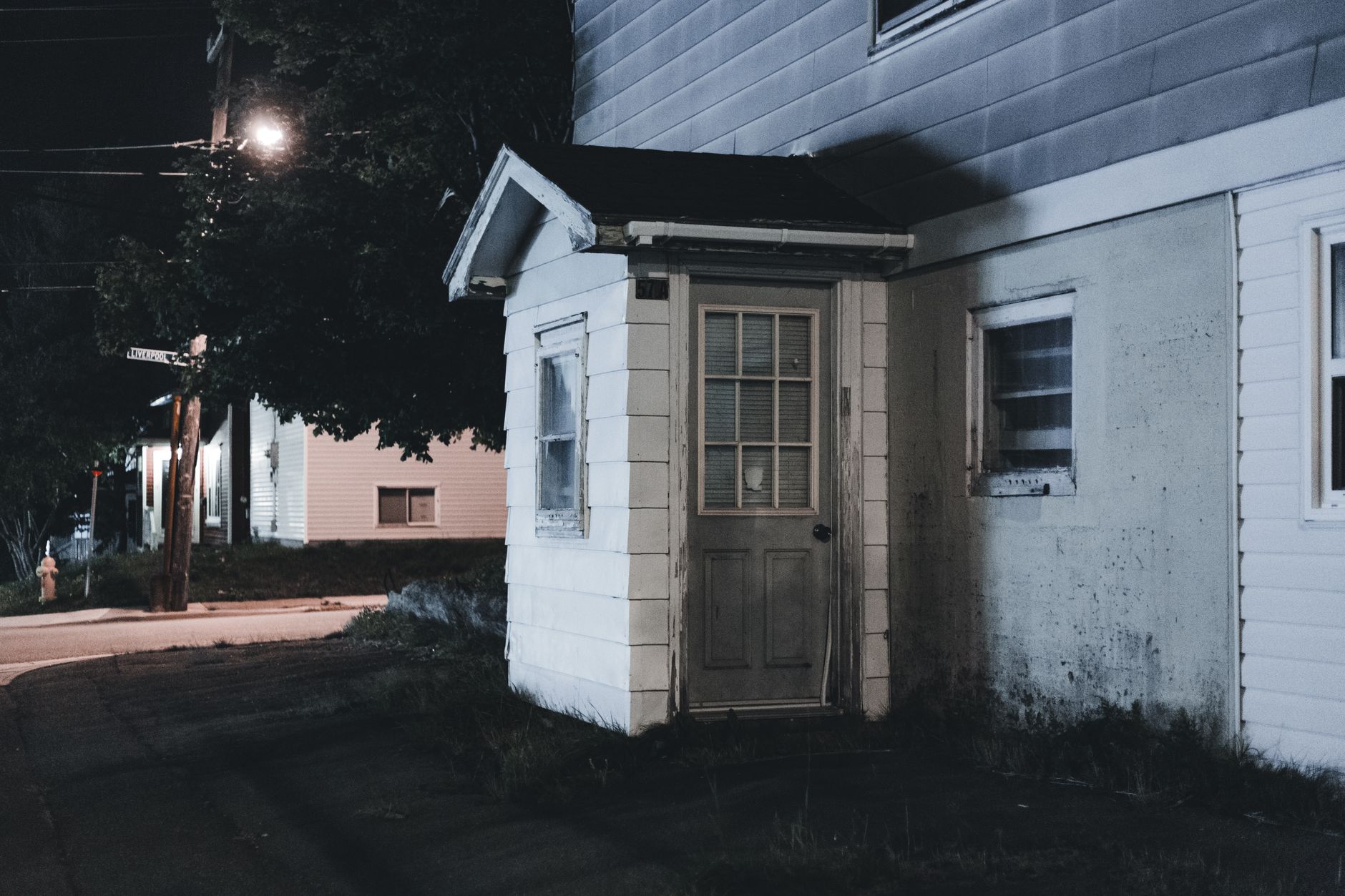 A side door of a house at night