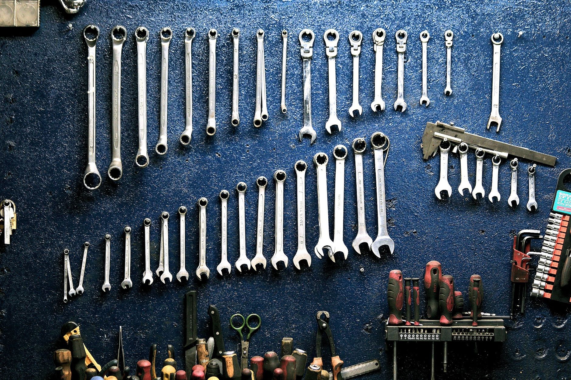 Wrenches hanging on a pegboard