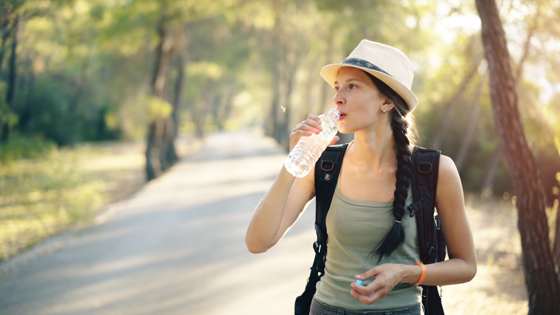 A hiker drinking from a water bottle