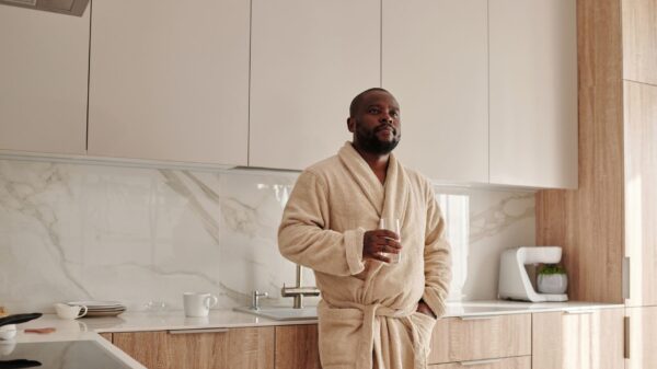 A man drinking water in a modern kitchen