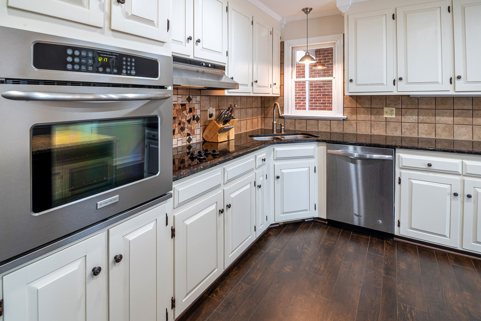 Kitchen with white cabinets and wall ovens