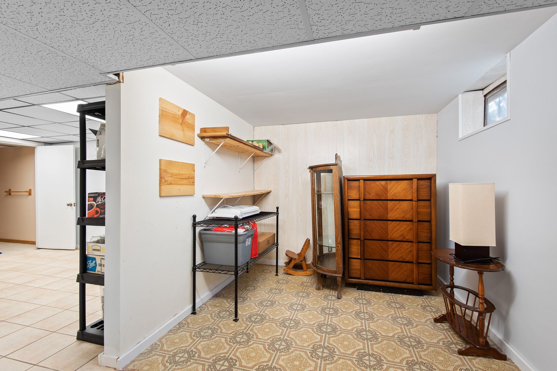 A finished basement room with shelves