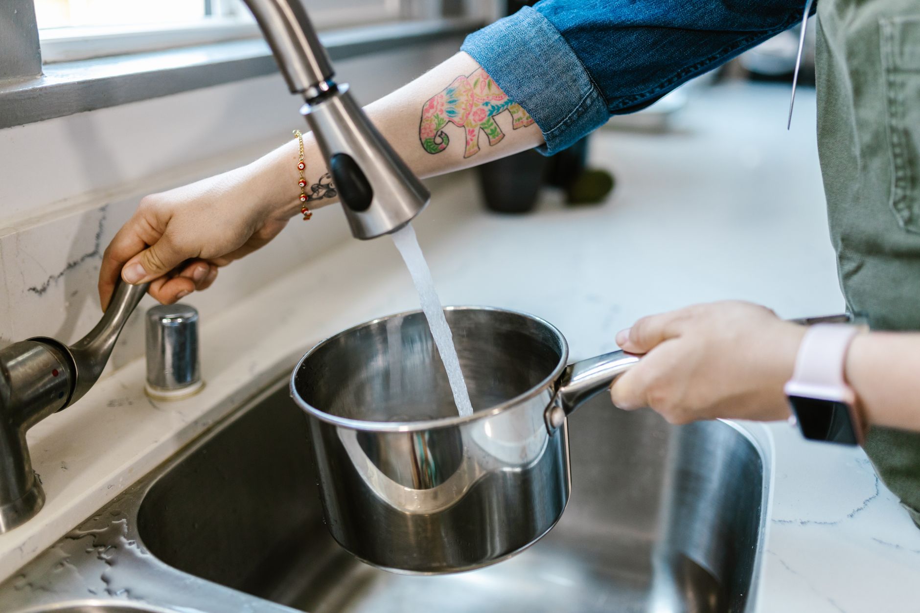Filling a pot at a kitchen faucet