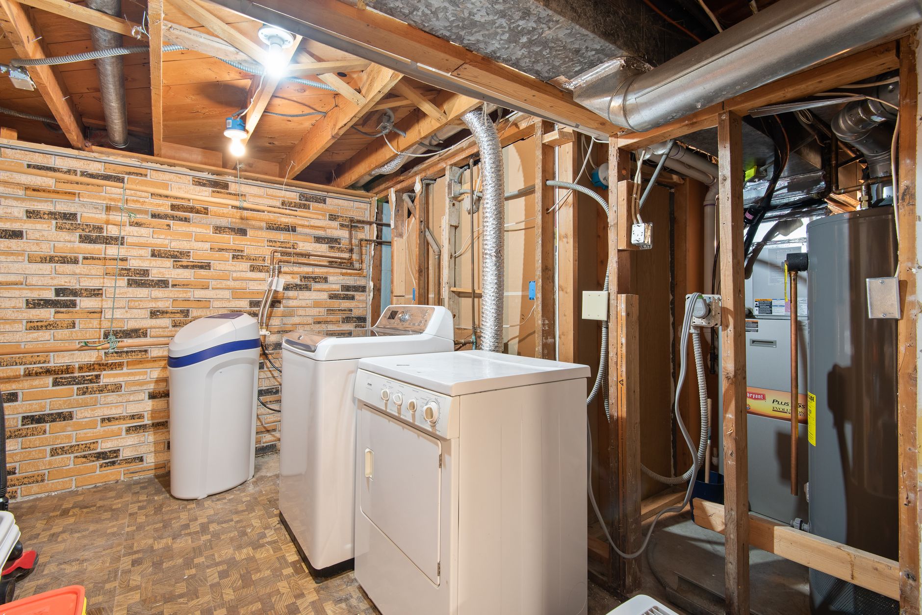 A basement with a water softener and washer