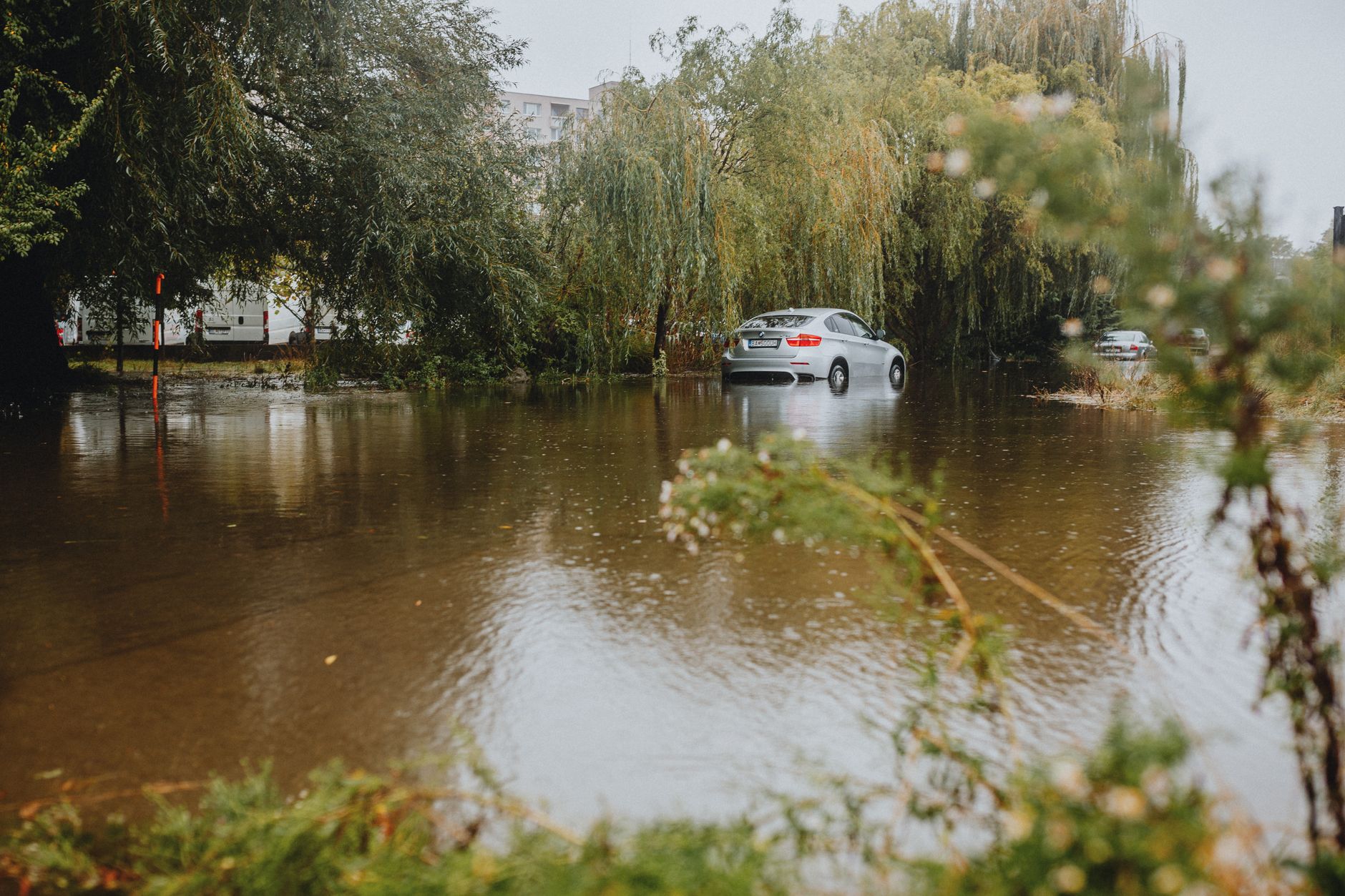 A flooded street with a car