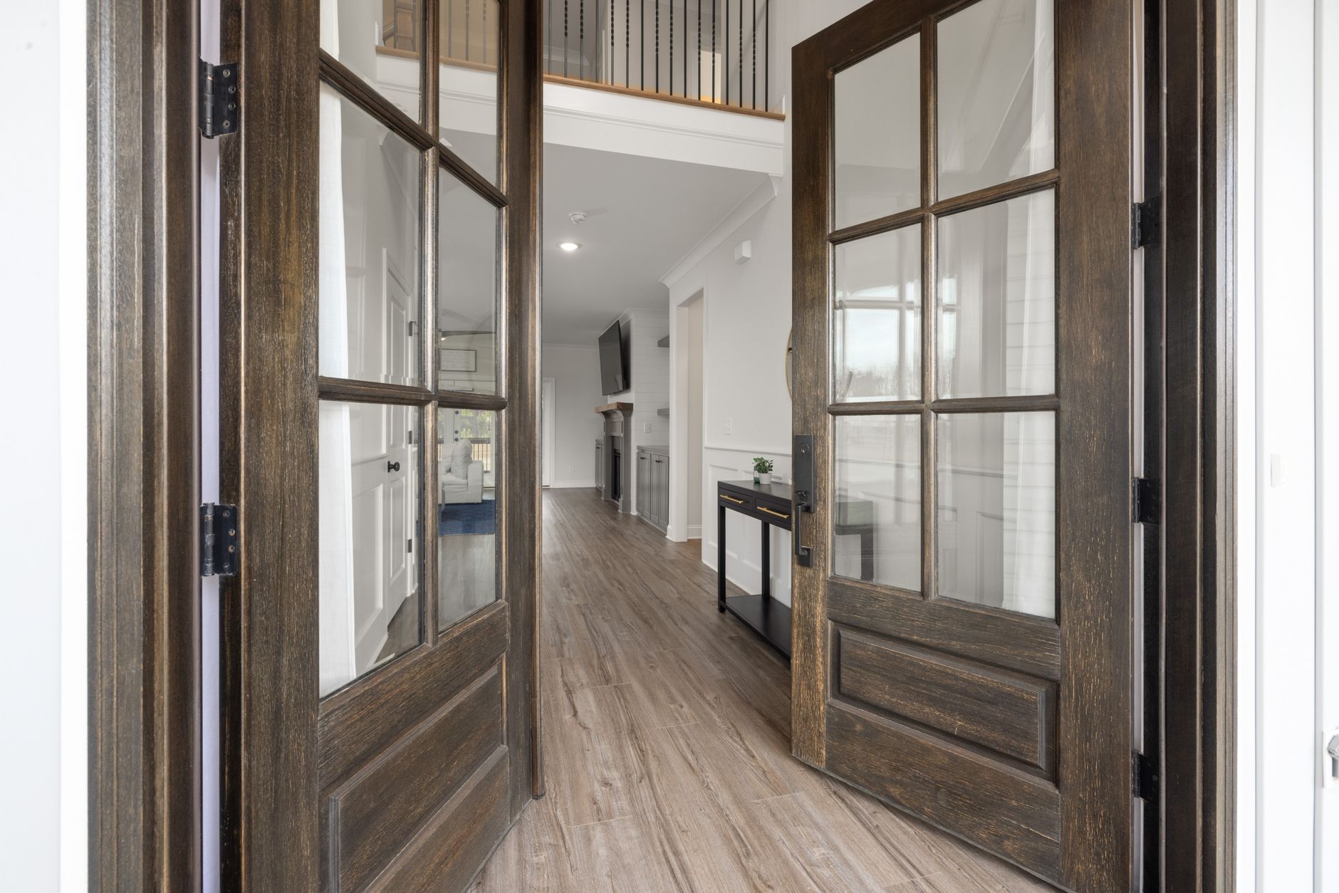 Glass-paneled double doors opening into a hallway