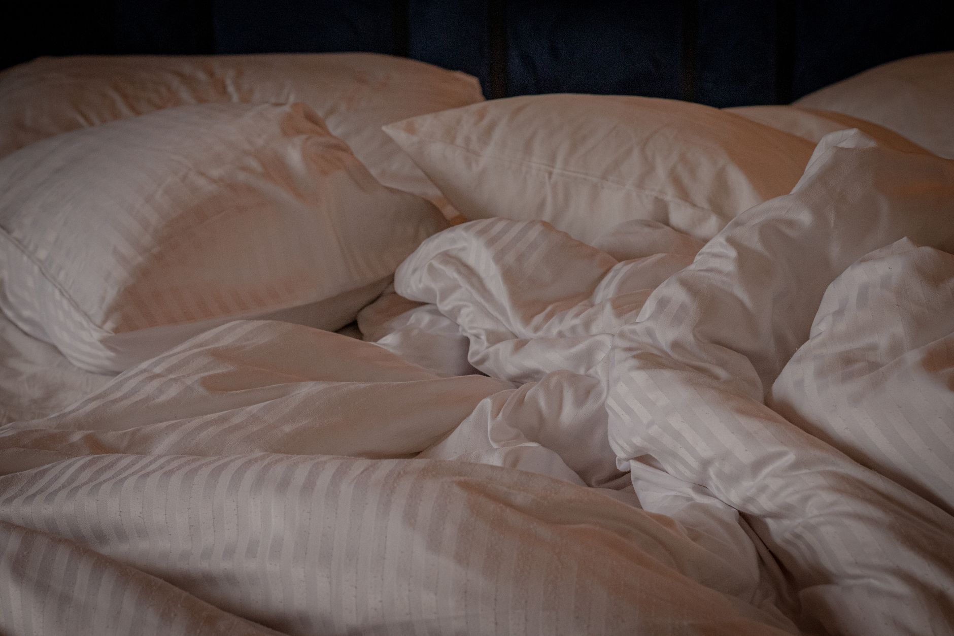 White pillows arranged on a made bed