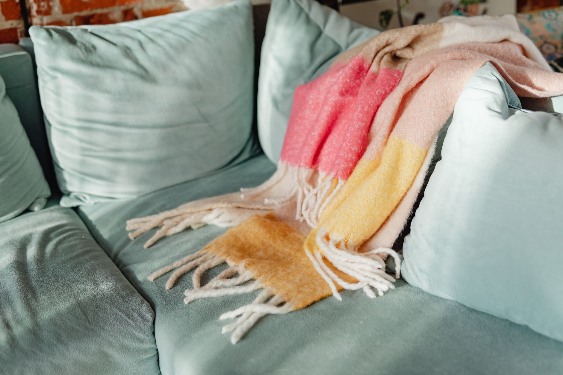 A striped throw draped over a sofa