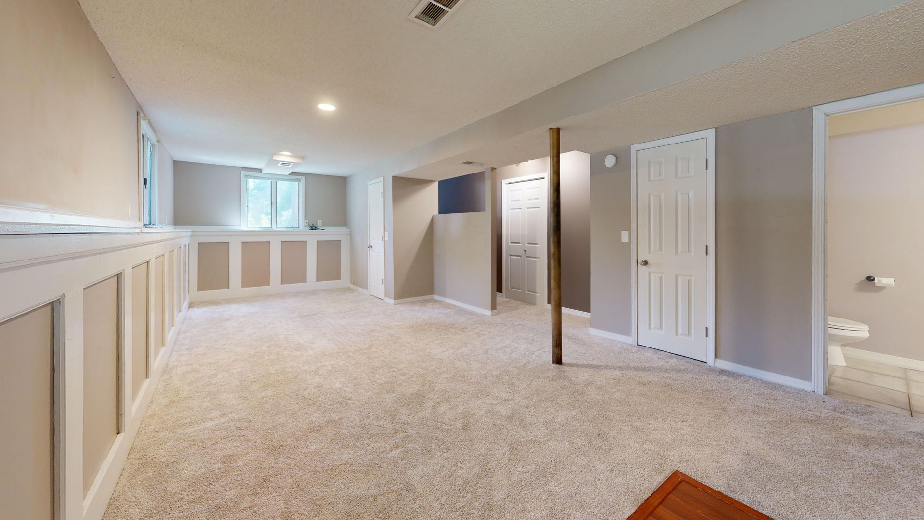 A finished basement with carpet