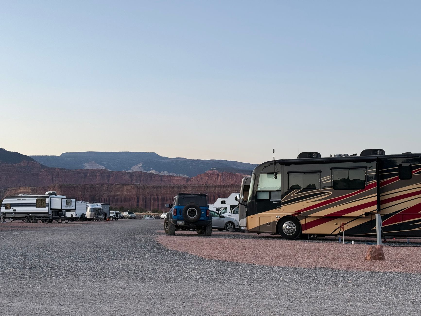 RVs and trucks parked at a desert campground