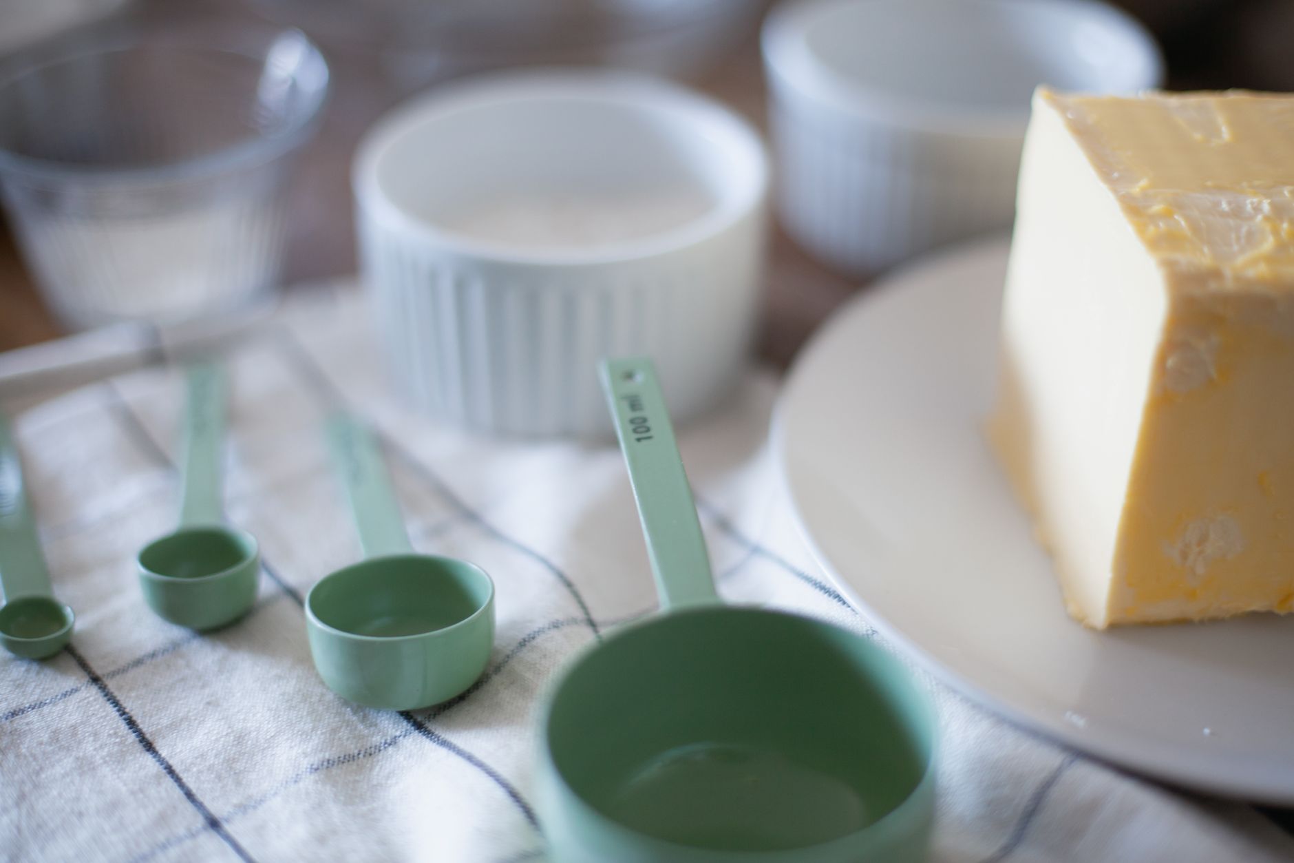 Measuring cups and butter on a counter