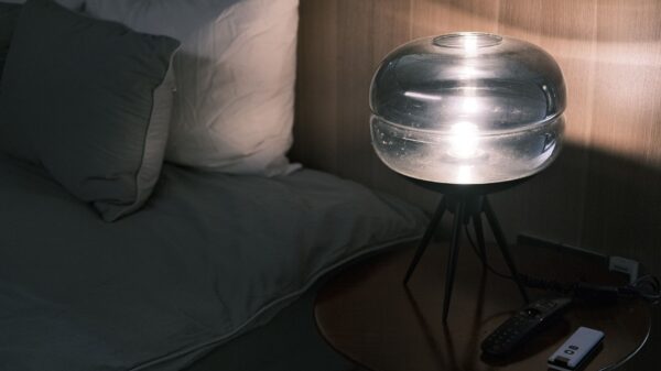 Best white noise machine: a glass lamp on a nightstand by the bed