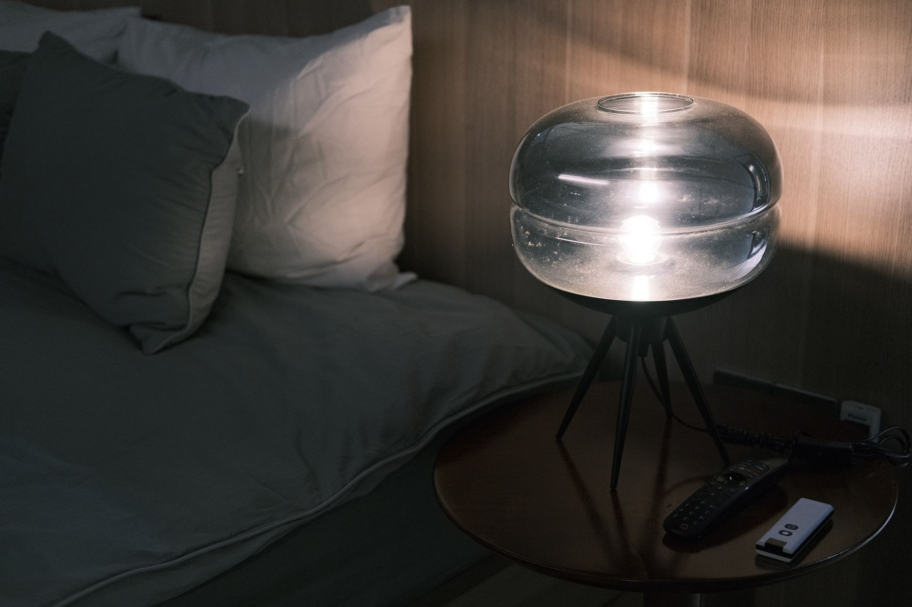 Best white noise machine: a glass lamp on a nightstand by the bed