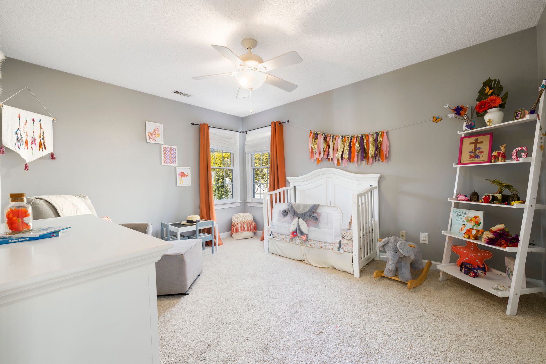 A nursery with a crib and toy shelves