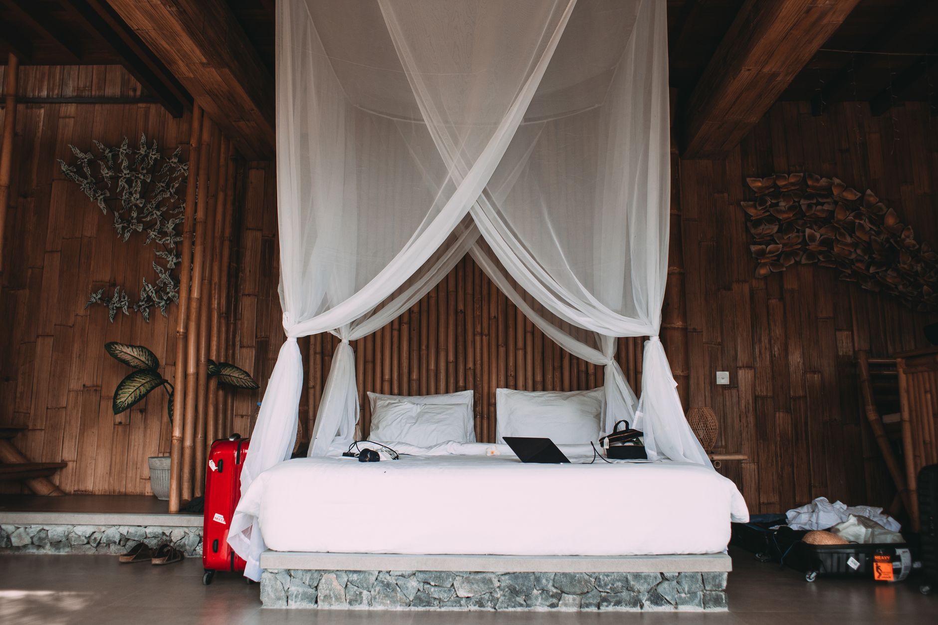A canopy bed in a wood-paneled room
