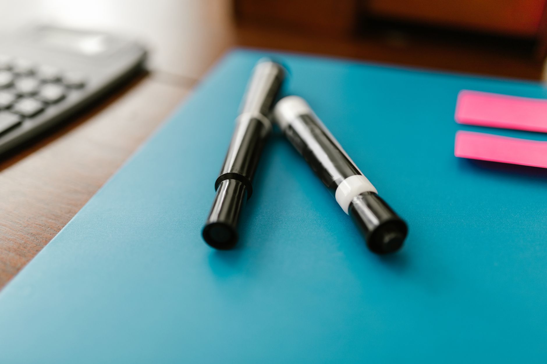 Markers and pens on a desk