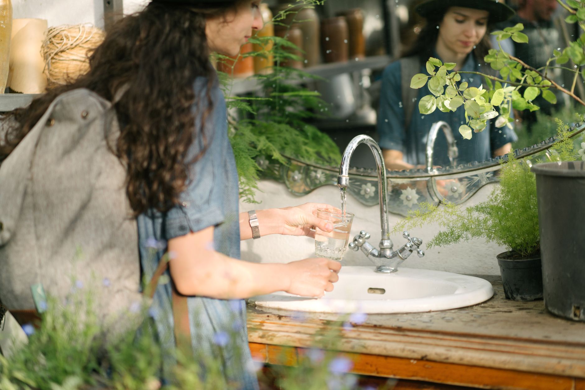 Filling a glass of water at a faucet