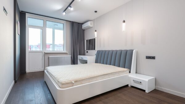 A bedroom with a wall-mounted air conditioner