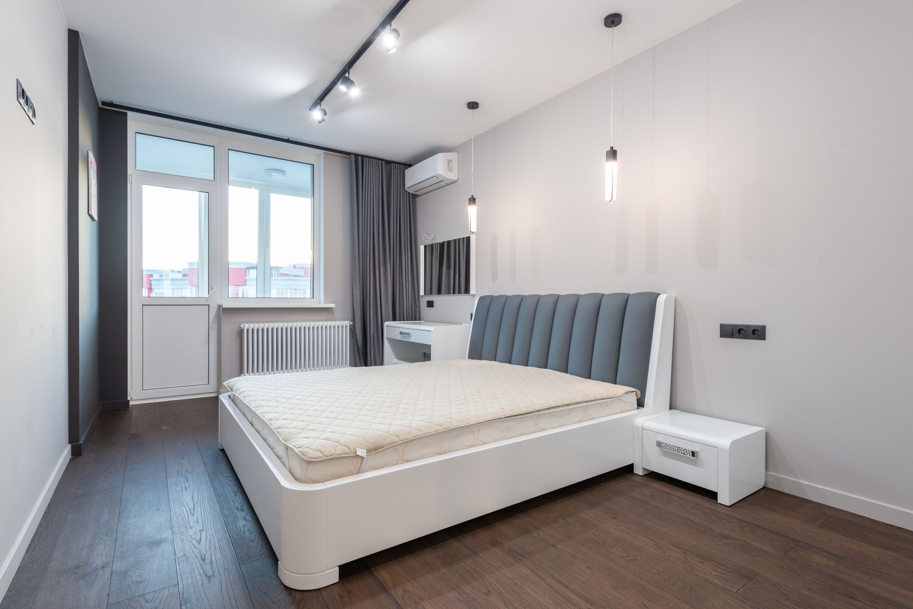 A bedroom with a wall-mounted air conditioner