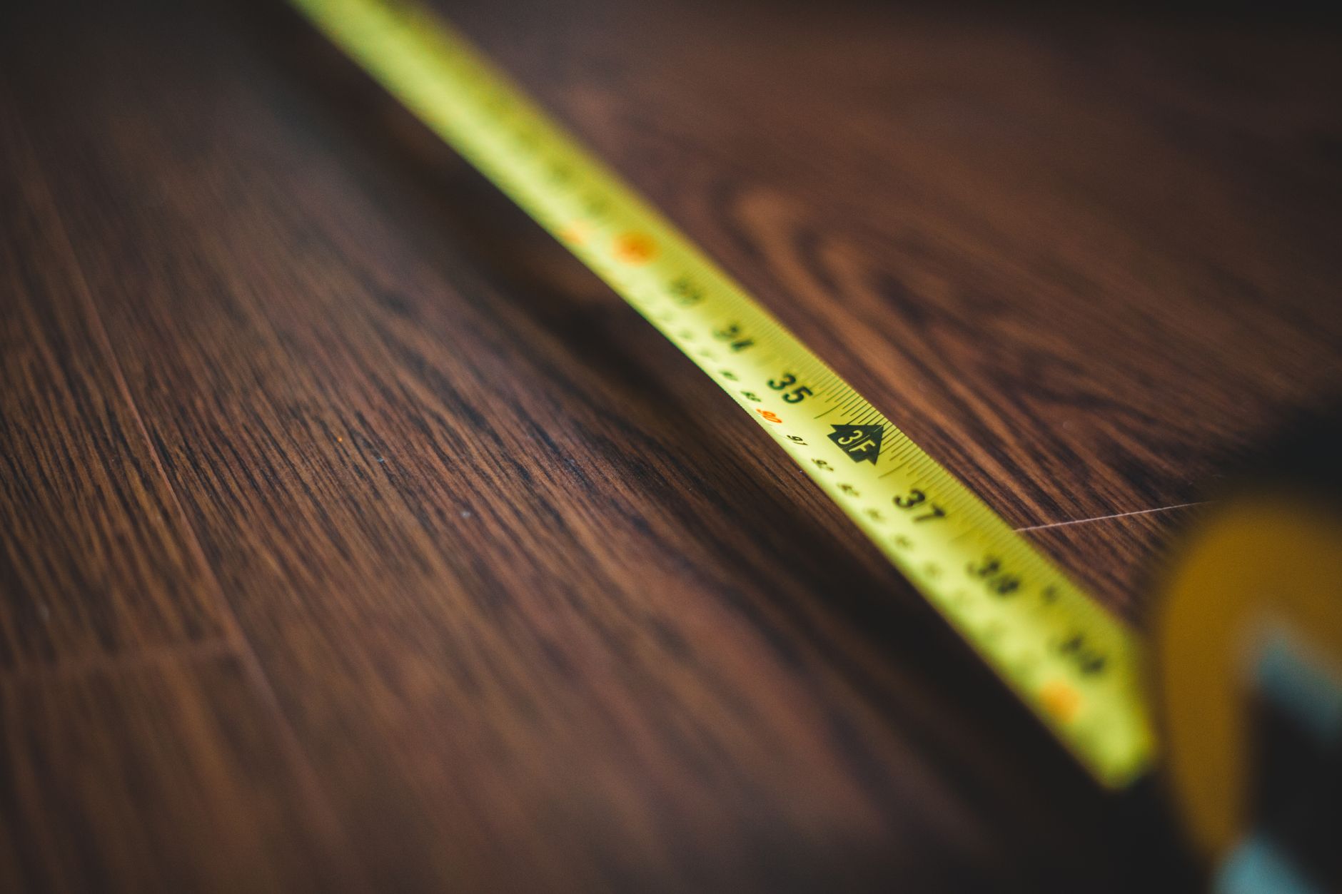 A tape measure on a wood floor