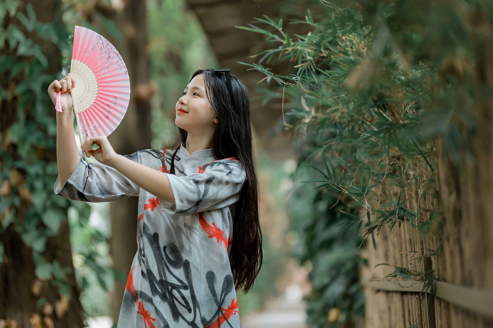 A woman cooling herself with a hand fan