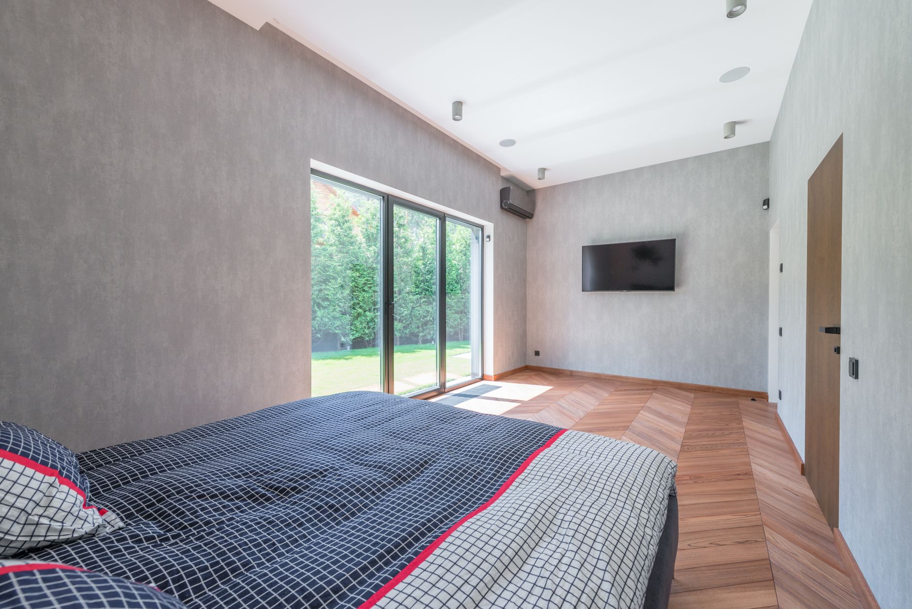 A bedroom with a wall of glass doors