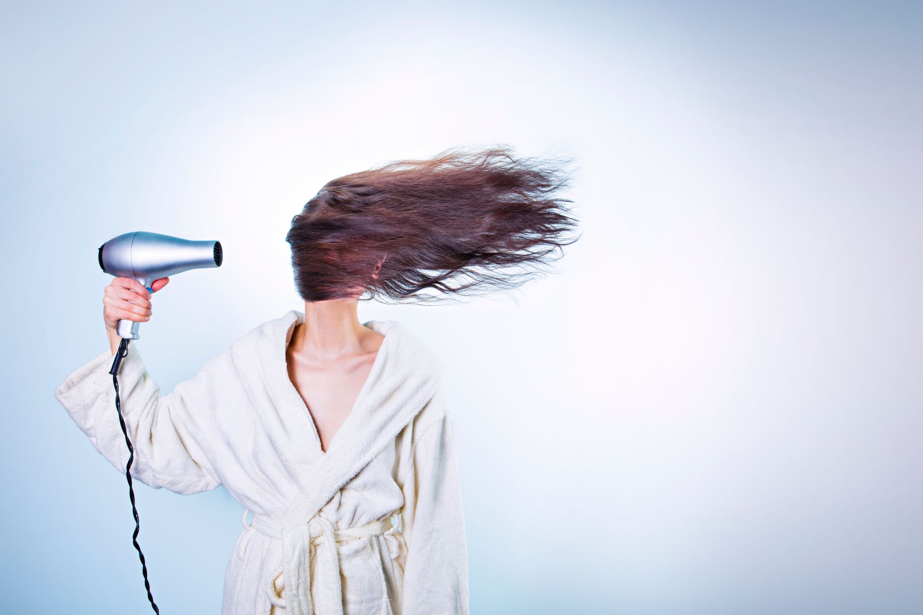 A woman using a hair dryer