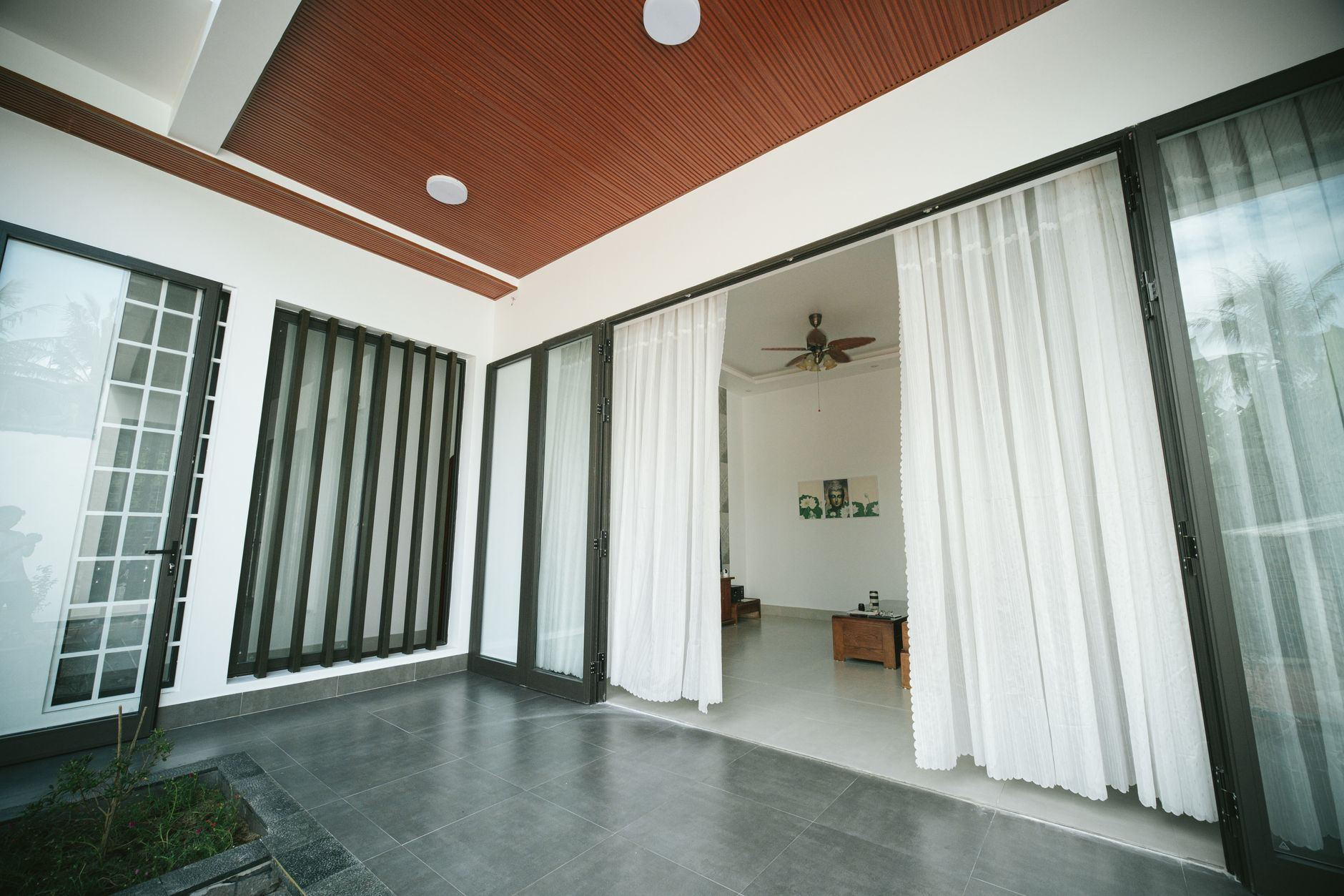 Sliding glass doors with sheer curtains in a bright home
