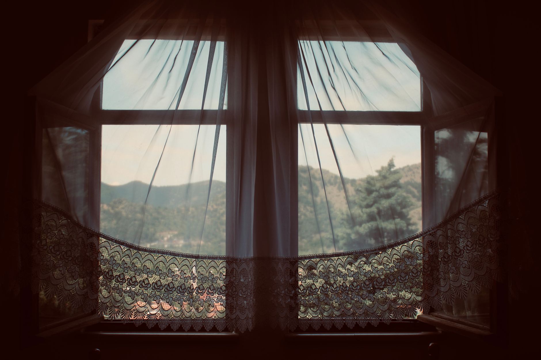 Curtains moving in a breeze from an open window