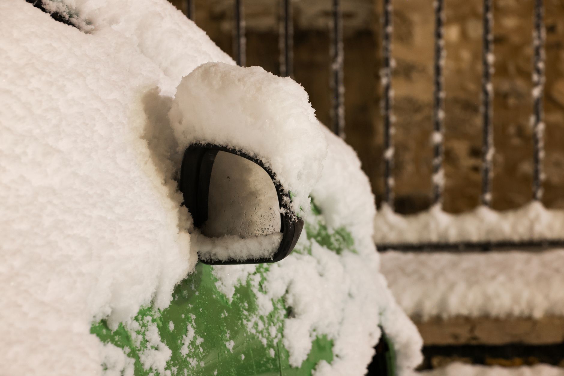 A parked car covered in fresh snow