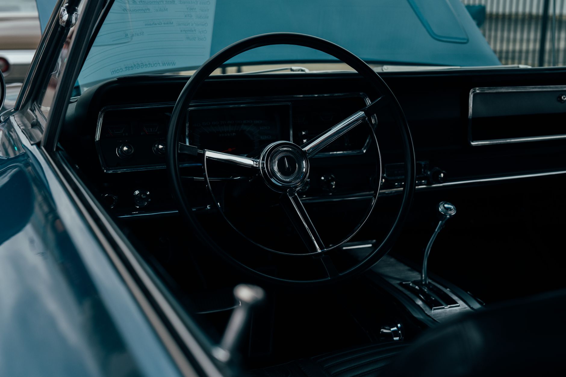 The dashboard and steering wheel of a classic car